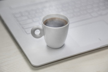 Fototapeta na wymiar cup of coffee on a notebook