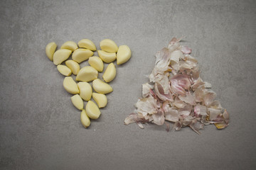 Garlic cloves folded in the form of an inverted triangle on the kitchen table top view