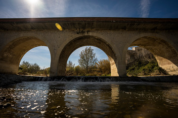 Old arch bridge over a river