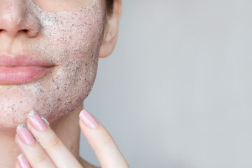  young woman does face peeling from black dots