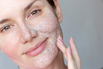  young woman does face peeling from black dots