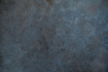 Dark artistic canvas backdrop. Abstract grunge background with dark grey and brown stains.