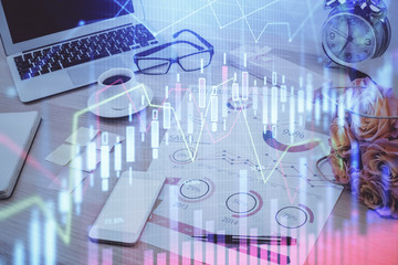 Stock market graph and table with computer background. Multi exposure. Concept of financial analysis.