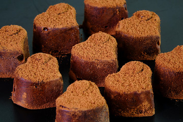 Heart shaped Nama chocolate, a type of ganache, made from a mix of melted cacao and fresh cream. As the mixture solidifies, and sprinkled with cocoa powder on top.