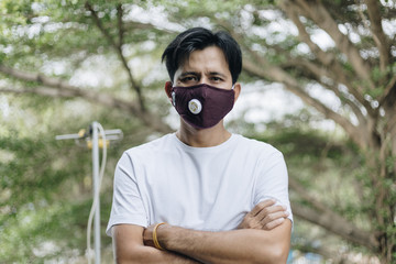 portrait asian man in protective surgical mask in face mask