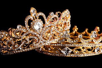 Golden Crowns Isolated on a Black Background