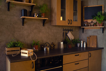 Close-up of interior design kitchen. Modern domestic dark interior of kitchen cabinets and shelves with cookware.