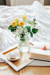 Lazy morning in bed. Flowers and tea for two.