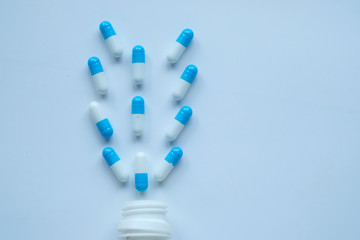 Close up of white pills on wooden table, health and medicine 