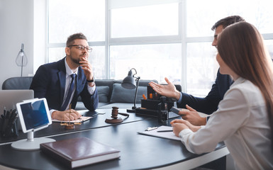 Male lawyer working with clients in office