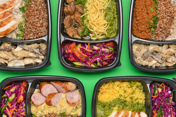 Containers with healthy food on color background