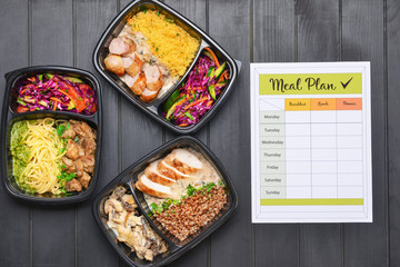 Containers with healthy food and meal plan on wooden background