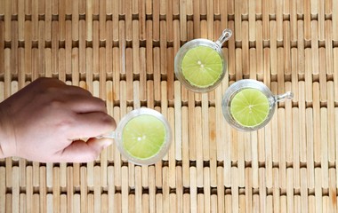 Gin tonic glass of juice on wooden table
