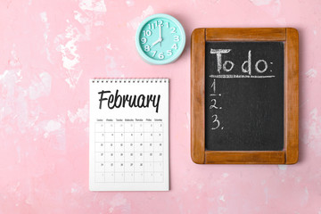 Calendar, chalkboard and alarm clock on color background. Time management concept