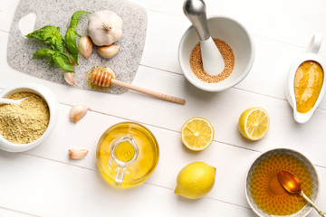 Ingredients for honey mustard sauce on white wooden background
