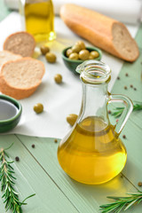 Bottle of tasty olive oil on wooden table