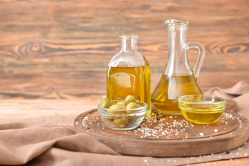 Tasty olive oil on wooden board