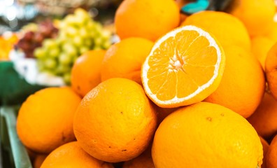Closeup shot of oranges neatly displayed in a market stand