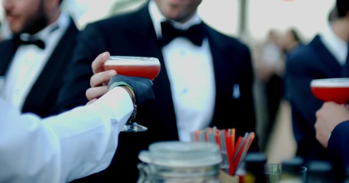the barmen giving to cocktail to a man