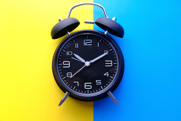 top view of alarm clock on color background 