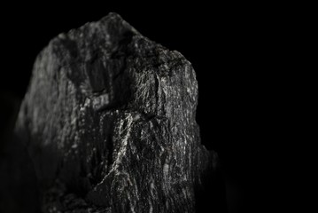 Closeup shot of an Igneous rock isolated on a black background