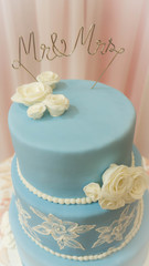 A closeup of a blue wedding cake