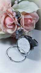 a compact, bracelet, and bouquet for bridesmaid