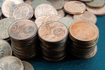 One, two euro cents coins on dark background. European money.