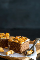 sweet brownie garnished with cashew nut in a dark background.