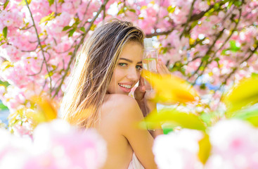 Fototapeta premium Cosmetics. Makeup remover. Healthy skin. Nature beauty. Woman with bottle of micellar water. Skincare. Beauty treatment. Micellar water. Cleansing water. Face tonic. Rose water. Wellness.