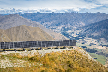 photovoltaic solar panels on the slope above valley in Mount Aspiring National Park, South Island, New Zealand