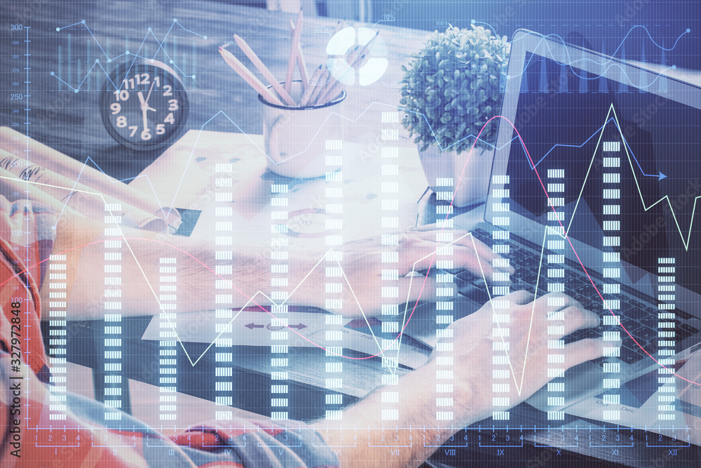 Poster double exposure of stock graph with businessman typing on computer in office on background. concept 