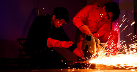 Male welders working together at site.