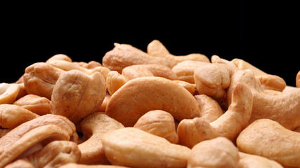 Pile of roasted cashew nuts on the table.