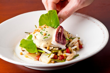 Scallops. Pan seared jumbo sea scallops, sauteed in garlic herb butter and plated with fresh vegetables and a reduction sauce. Classic French Bistro Dish.  Plated by a chef