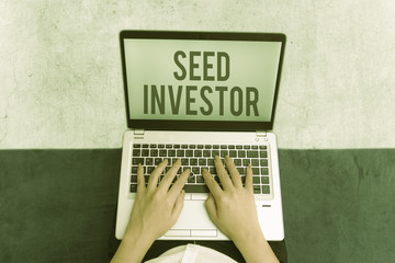 Writing note showing Seed Investor. Business concept for source of initial money required to start...