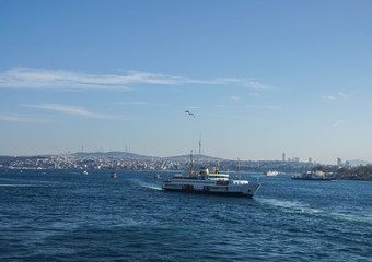 Istanbul / Turkey - December 9 2019: luxury cruise and passenger boat tour in Bosphorus Black Sea in blue sky sunny day in winter