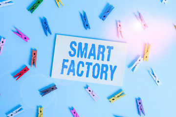 Conceptual hand writing showing Smart Factory. Concept meaning A highly digitized and connected production facility Colored clothespin rectangle shaped paper blue background