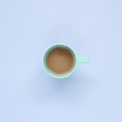 Cup of coffee on pastel purple background. top view, copy space