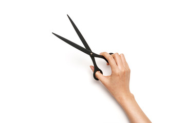 Woman hand hold a scissors with paper isolated on white.