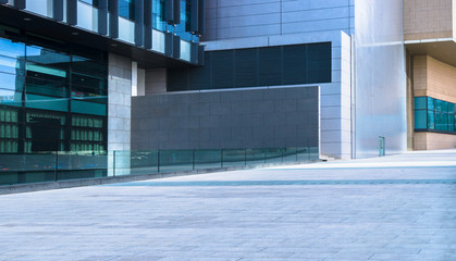 Fototapeta na wymiar Financial and commercial center building exterior with sidewalk and pedestrian plaza closeup.