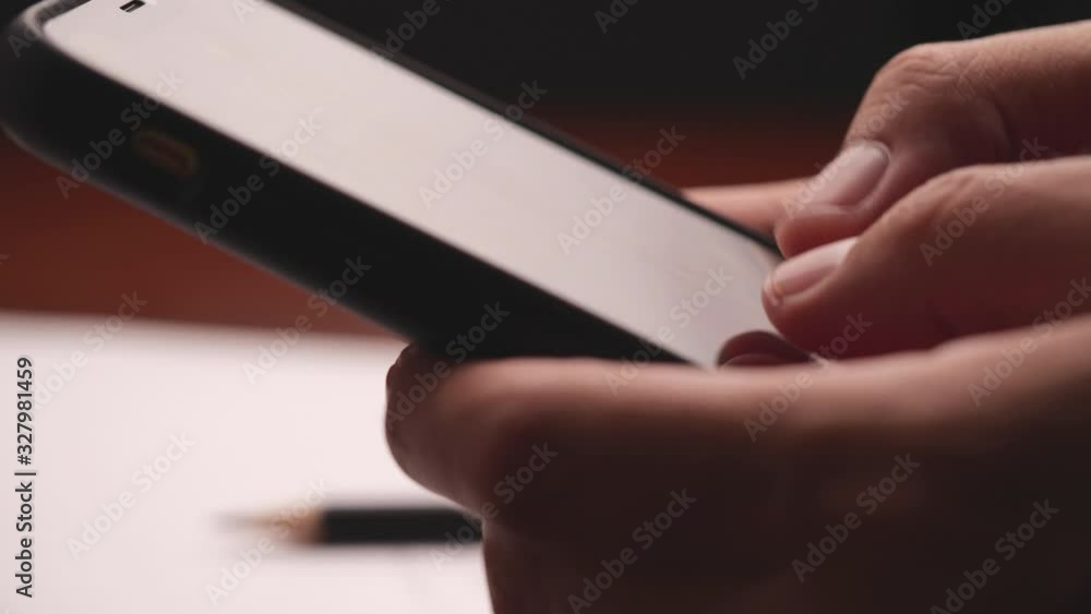 Poster Closeup of hand using smartphone. Male typing text message via cellphone, social networking concept