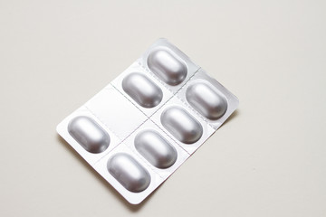 silver blister with pills on white background