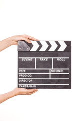 Woman hand hold a movie clapper isolated on white.