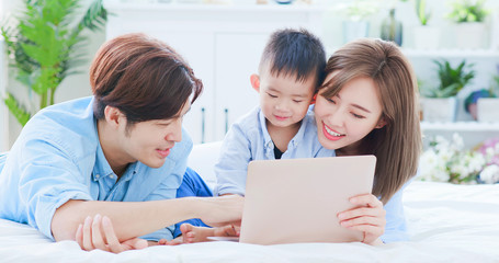 Fototapeta na wymiar Parent play laptop with child