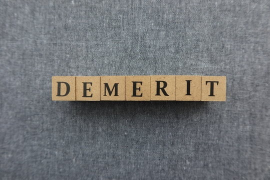'DEMERIT' word made with wooden blocks
