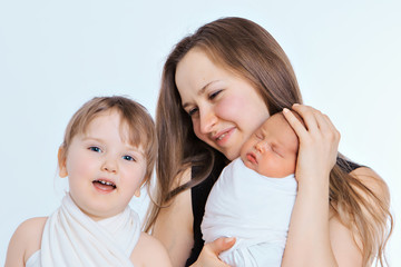 concept of healthy lifestyle, the protection of children, shopping - baby in the arms of the mother. Woman holding a child. Tree girls. Isolated on white background. Copy space. 8 march, mother's day