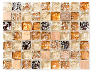 Sample small glass multicolored tile on a plastic grid.