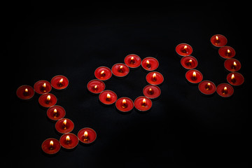 Candles burning on a black background