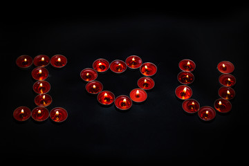 Candles burning on a black background